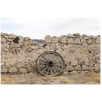 Wagon wheel against a stone fence at Hueco Tanks State Park, northwest of El Paso, TX-Paper Art-26"x18"