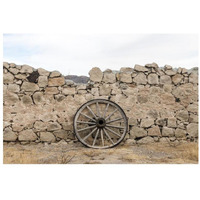Wagon wheel against a stone fence at Hueco Tanks State Park, northwest of El Paso, TX-Paper Art-32"x22"