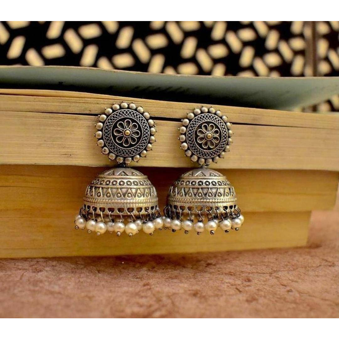 An interesting mix of dual tone finishing translates into this spectacular oxidised set that spell classy and stylish at the same time. Handcrafted in brass, with gold and silver oxidized plating, this classic set of 5 containing a long haram, a pair of earrings, ring, nose pin and a set of bangles, captures the unwind regal romance and can be paired with your Indian or indo western attires to look stellar.