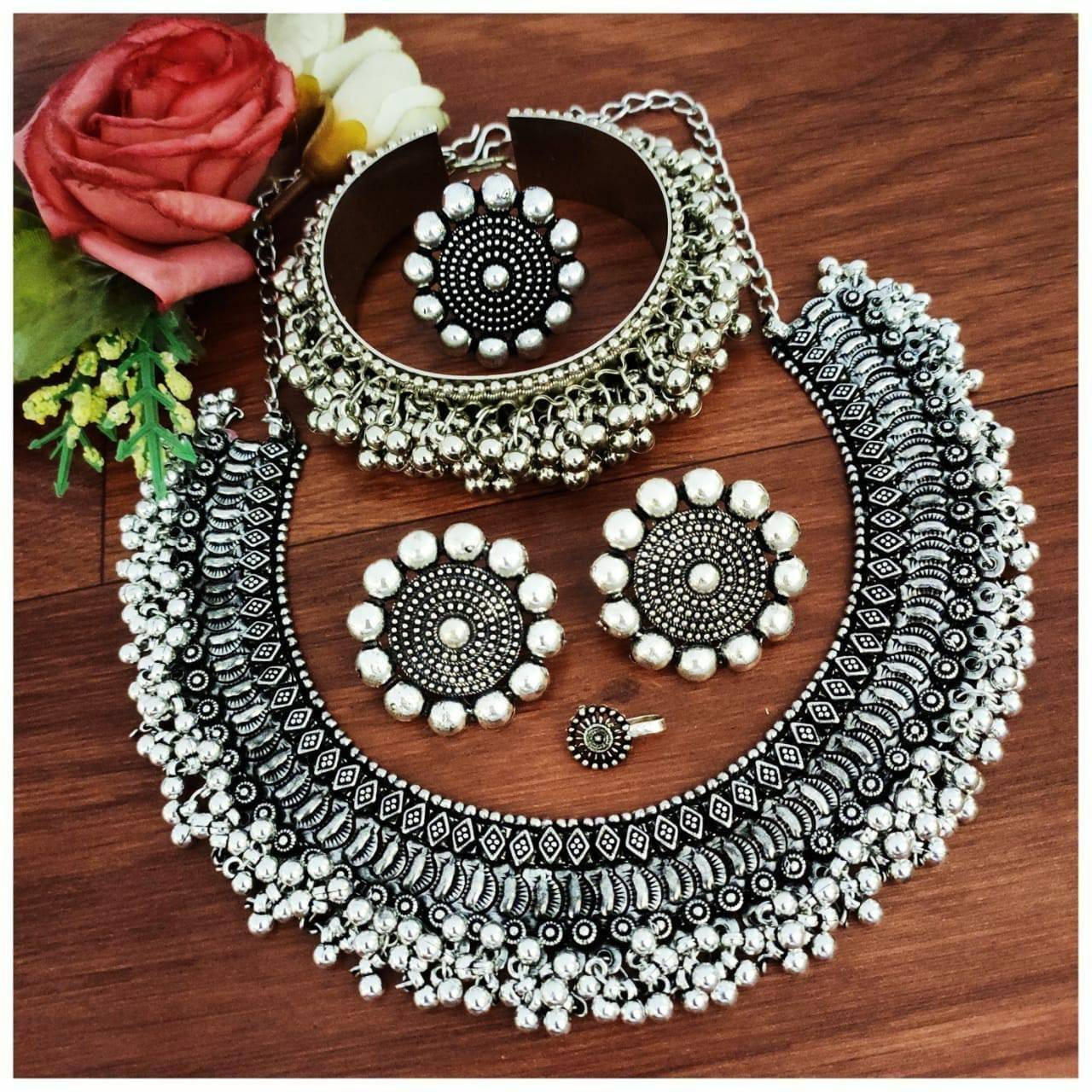 This set of 6 includes ghungroo necklace, hand harness, pair of anklets, stud earrings, toe ring & nosepin Celebrate every occasion with timeless pieces. Bringing you a unique box of Accessories that will brighten up your days in an instant Our Ghungroo Silver Oxidised Jewelry Set features a minimalist look. Each of these pieces is versatile and complements each other. Wear them together or separately, these are bound to shine Our Timely Treasures are the perfect gifts to give your loved ones
