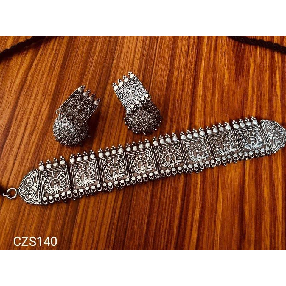 The drama of a Silver Antique Pearl Dangler Earrings. Statement as well as light weight pair of earrings are crafted with black silver work mixed with pearls. Bits ofpearlswith oxidised chandbalias a playfully drop. The movement of the earrings adds value to the look. This one is a statement maker, youd use to dress up just about any outfit.