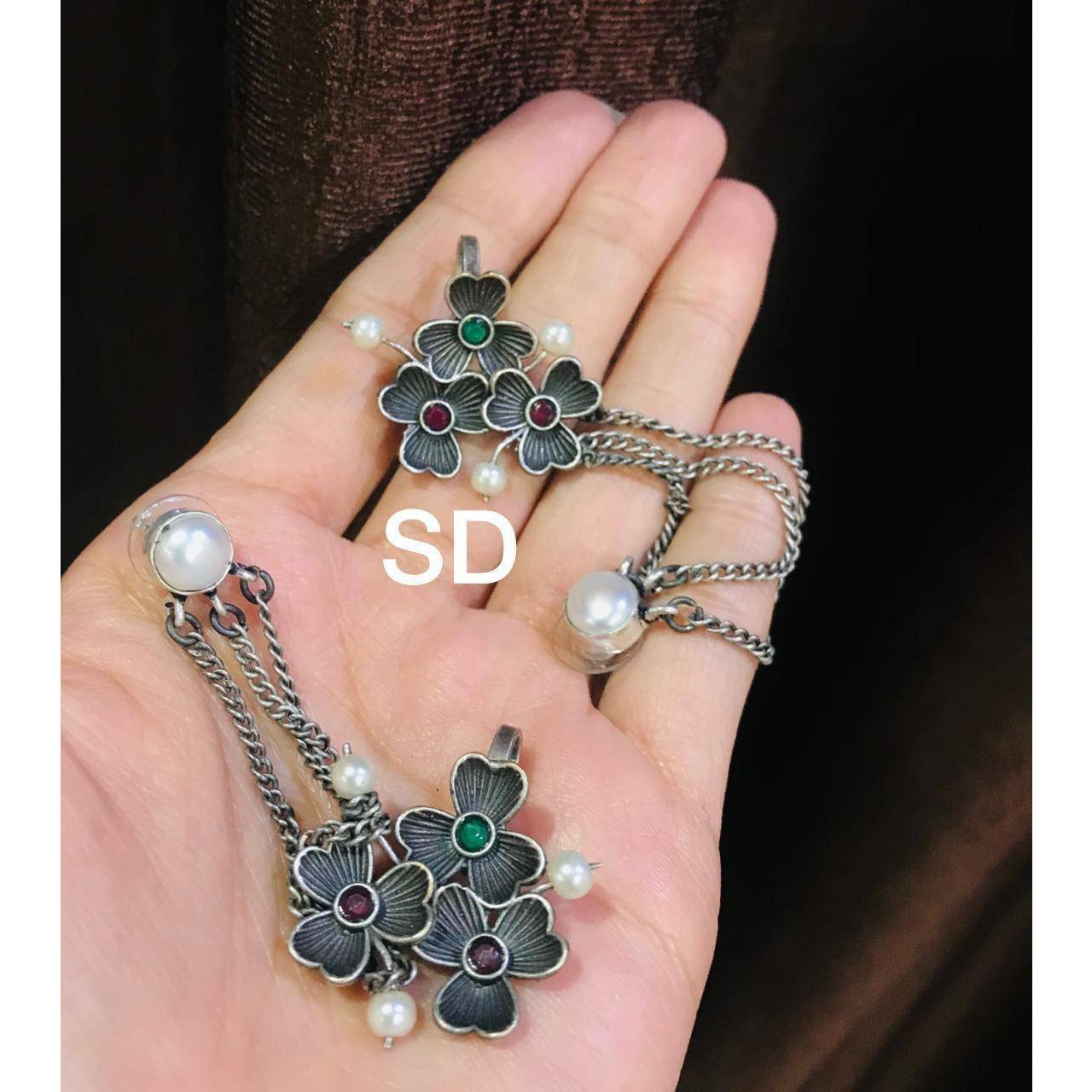 Earrings and rings are those quirky accessories that adds up to your style statement. This is where we present you the most stylish and vibrant collection of jewellery where you just cant go wrong. Get this beautiful spherical ring and dangle earrings adored with a bunch of faux studs and beautiful art engraved over it. Make your presence felt with your stylish