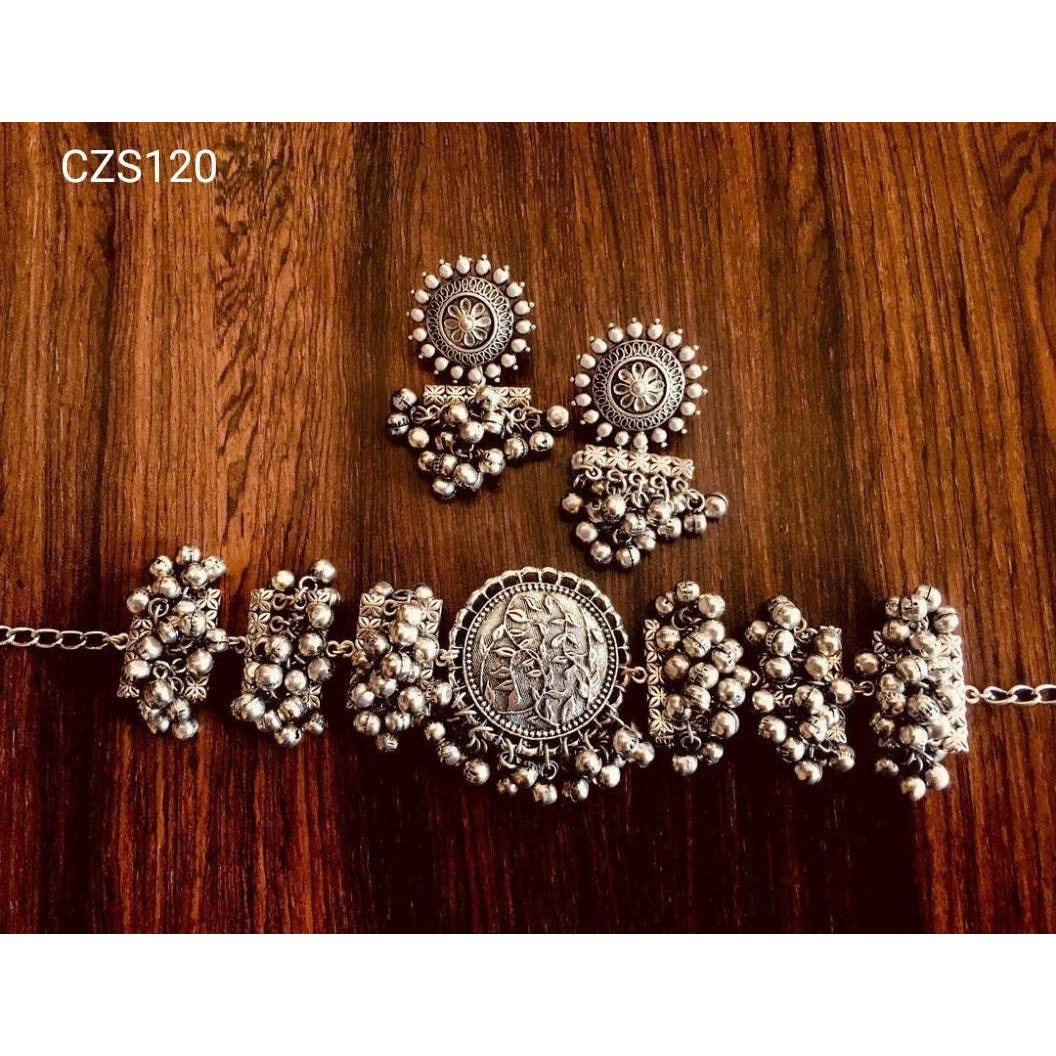 Do you like to flaunt German silver jewelry Vastrabhushan has created the most elegant oxidisedchoker set with a bracelet, oxidized earrings, a fine necklace, pin and a ring. The 5 piece set is anexample of handcrafted brilliance and reflects the innate charm of Indian jewelry. If you want to getcompliments and turn heads, try this jewelry set with your favorite dress. It will certainly make astyle statement. You can also gift this premium quality necklace set.Jewelry care tips Always ke