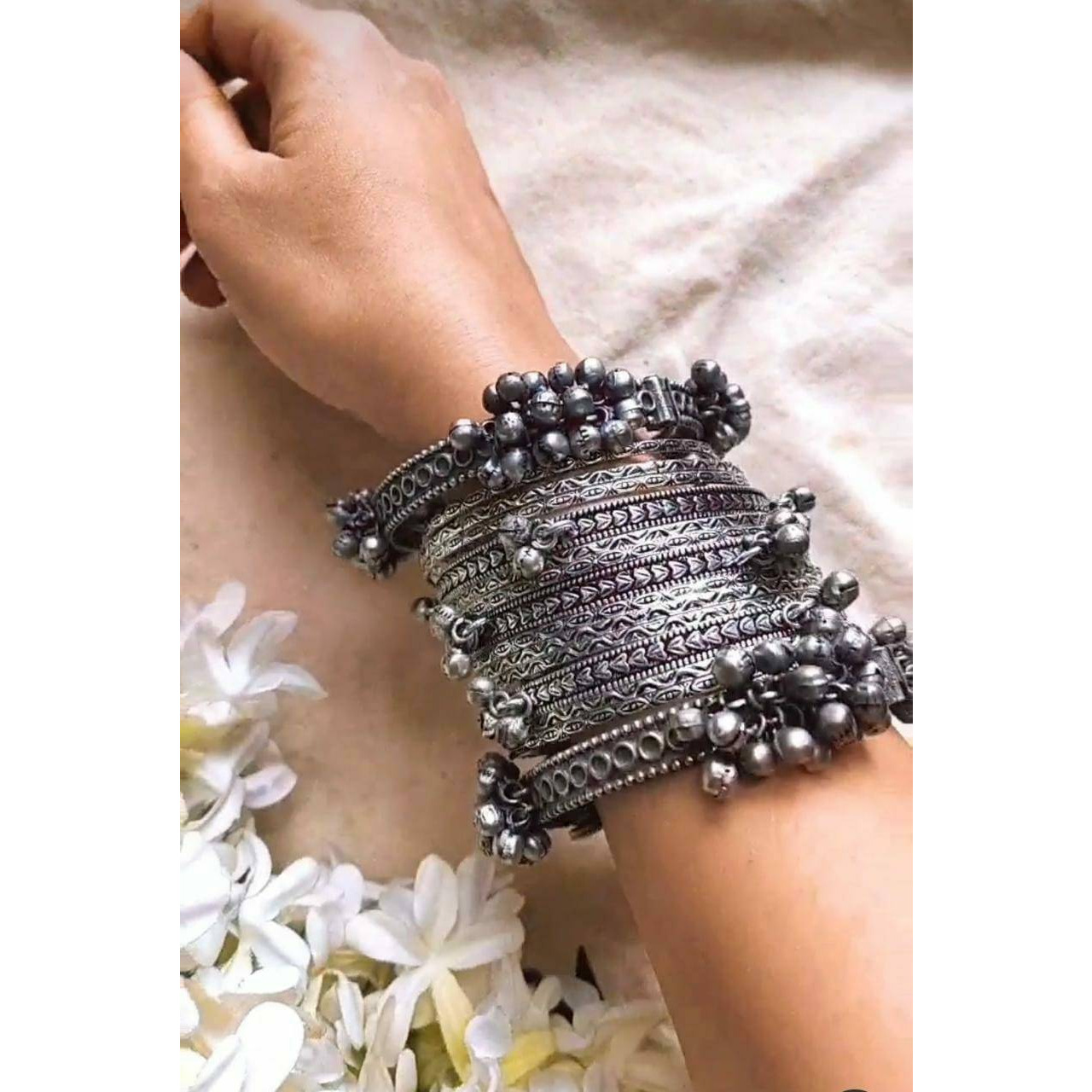 Are you obsessed with jhumkas Do you own a matching pair with every outfit Then you are bound to fall in love with this limited-edition pair of big, long jhumkas. They come with a metallic black polish that gives them a dull sheen. This piece of oxidized jewelry comes with cute little silver bells that give it a hippie, boho look. Intricately designed, these ornate earrings have the essence of traditional Indian jewelry. You can wear these to celebrations and parties, and they are also an idea