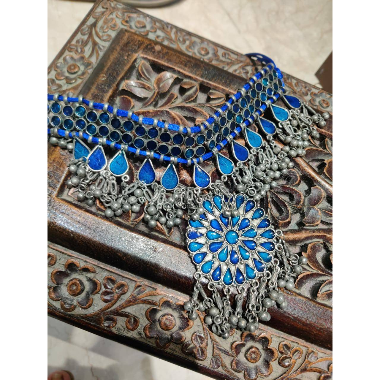 A lovely chime to adorn your wrists, thisIndian jewelry sethas been handcrafted by our in-house artisans in oxidized German silver, specifically chosen for you. This Indian oxidizedbangle Kada bracelet adds just the right amount of bling to your ethnic outfits. This kadabracelet is made of German silver and has gleaming bells that make a charming tune. This isthe perfectGerman silver Indian jewelrythat will complete your appearance with the leasteffort and the highest level of fl