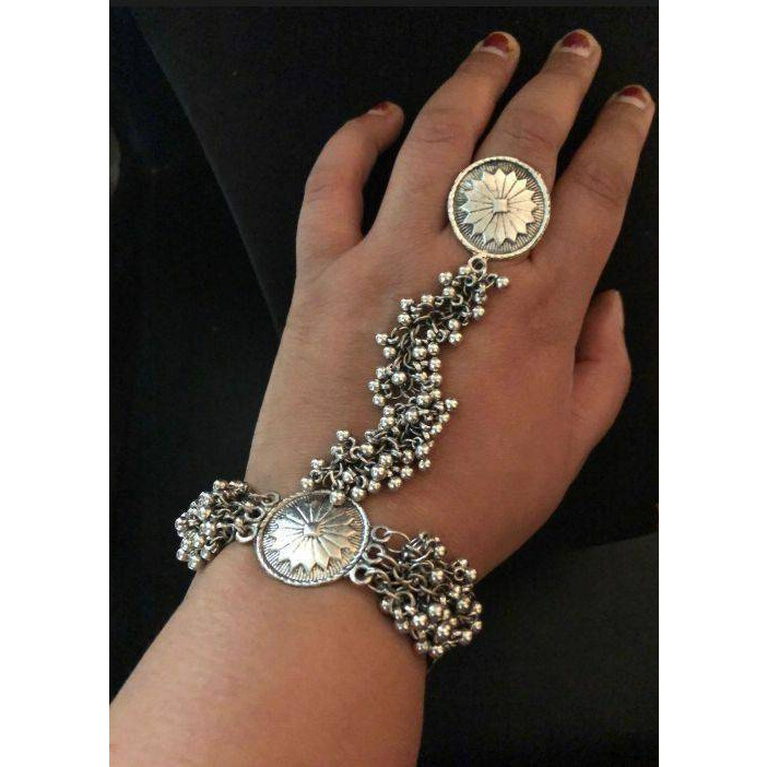 A quirky bold ring that will draw attention immediately when it's on you It is a one-of-a-kind piece that will set you apart from the crowd. Crafted in german silver, this ring will add the right amount of drama to the look. This piece makes accessorizing effortless and complements most of your ethnic outfits.