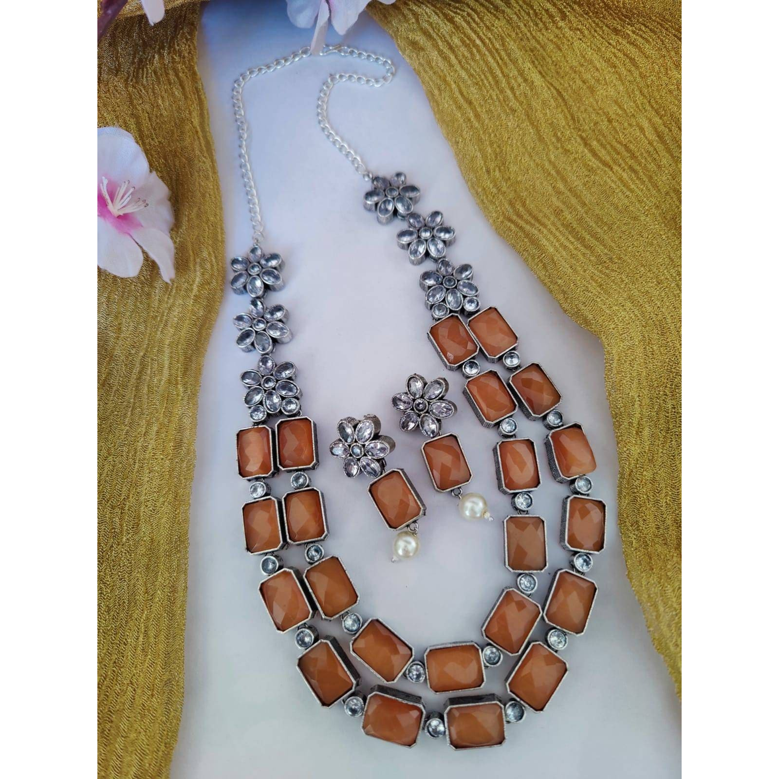We love how choker necklaces fall perfectly on the neck to give a bold and chic look. Our Antique Silver Polish Choker Necklace Set takes notes from the classic jewelry and captures beauty in filigree aesthetics combined with playful ghungroos. The necklace features intricate floral details with ghungroo making it grand and dramatic.Style this up with your favorite outfitOCCASION Will add lustre when worn for a wedding, engagement, party, prom and any special occasion. Will enhance special days