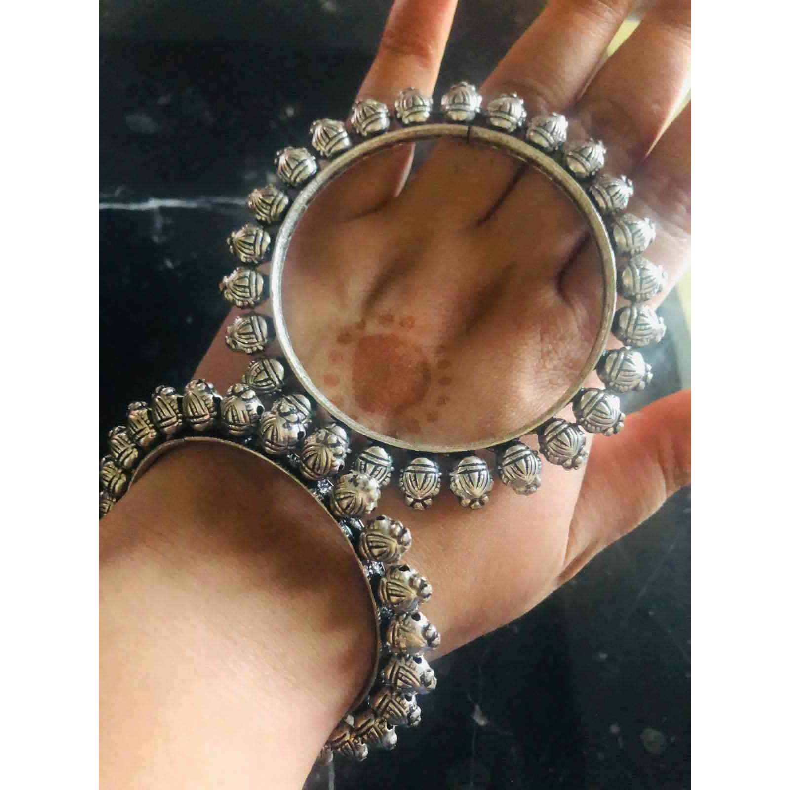 Vastrabhushan is one-of-a-kind Indian oxidized bangles are the OGs in your jewellery boxThese traditional baraat kadas are moulded with German oxidized silver to add a charm and class to a monotonous outfit. Available in 4 different styles, get one or many that fit your need. From silver kadas to broad SLA kadas,we have got it allThese antique-looking silver kada are perfect for weddings, festivecelebrations, and even for regular use. They are also an excellent present or gift for yourloved on