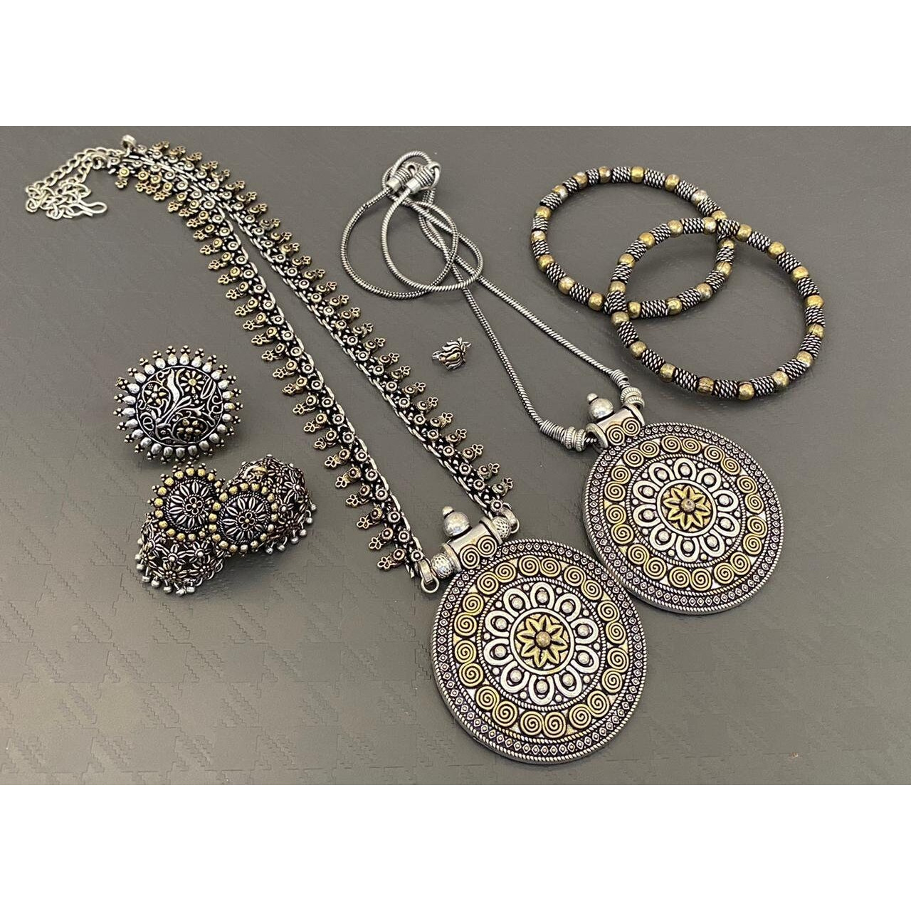 Add ethnicity and elegance to your personality with this exquisitely handcrafted Kohlapuri bangles made with high quality German Silver. Pair it up with any semi formal or western attire and gather compliments wherever all the way