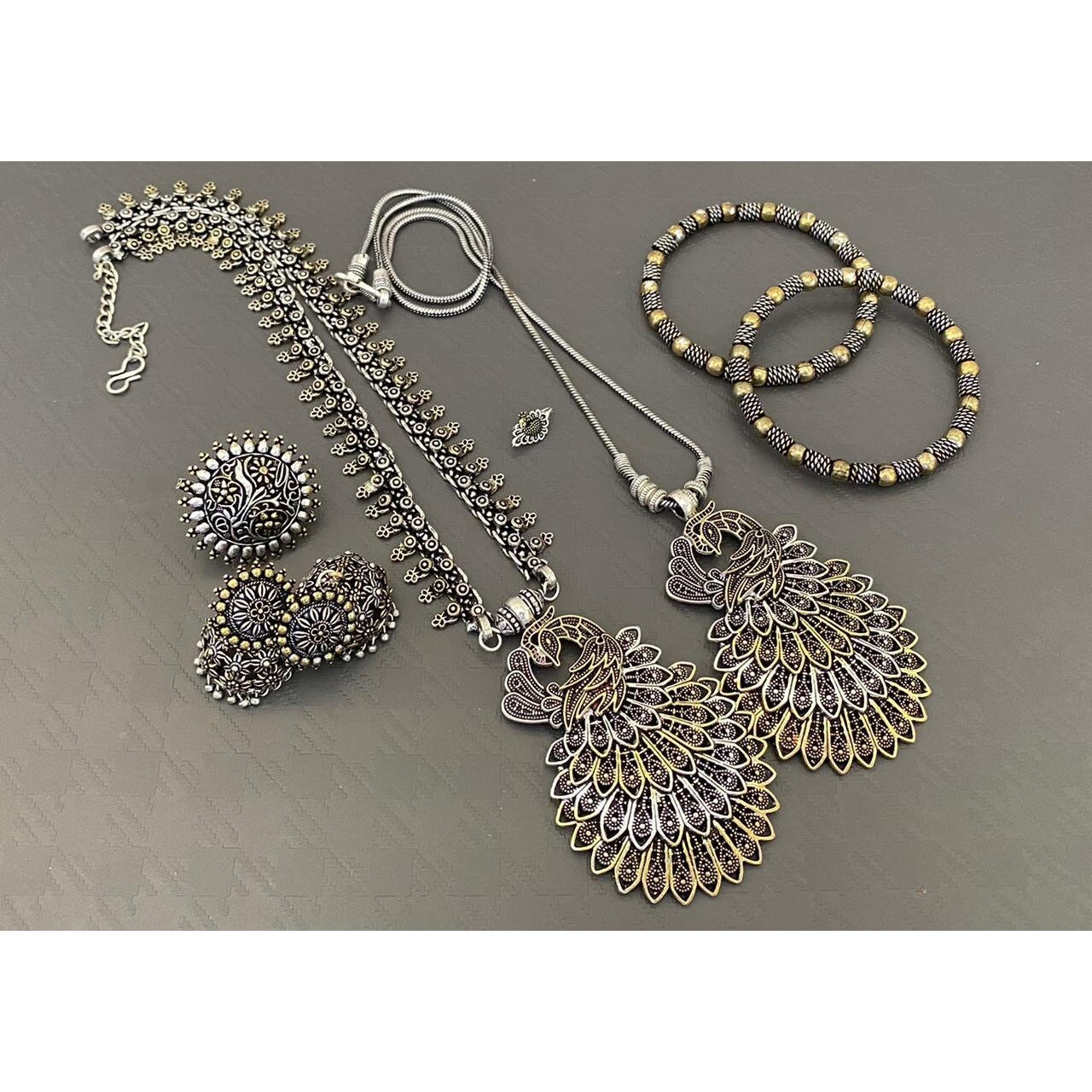 Add ethnicity and elegance to your personality with this exquisitely handcrafted Kohlapuri bangles made with high quality German Silver. Pair it up with any semi formal or western attire and gather compliments wherever all the way