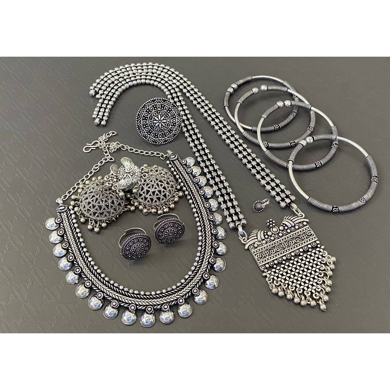 This season, style up with a necklace set that spells opulence. This necklace set falls on your neck with grace. It features delicate yet striking details that will leave you feeling pretty all day long. It is crafted in german silver with Multicolour stones and a bold pendant that boasts an intricate and detailed design with pearls. This necklace celebrated the rich Indian culture and spells novel folklore. Style this up for a rich festive look.