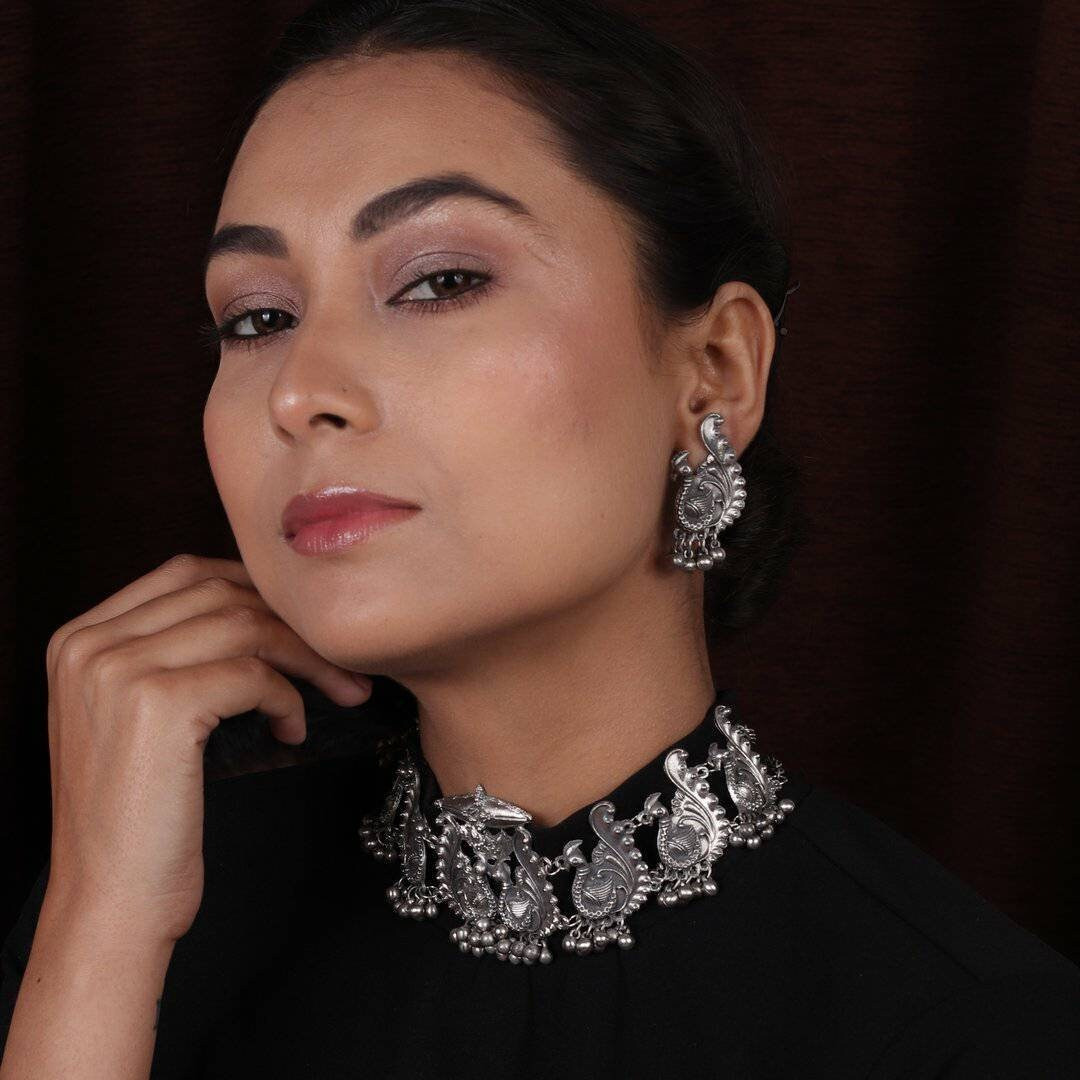 We can't get enough of earrings These earrings feature the iconic Lord Ganesha design with Trishul and tiny pearl drops that surely reflect your lively personality. A pair of earrings that will awaken the jewelry lover in you. Festive styling goes easy with this pair of earrings. Style this up with your outfit for a rich look.