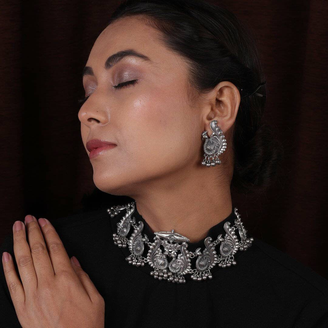 We can't get enough of earrings These earrings feature the iconic Lord Ganesha design with Trishul and tiny pearl drops that surely reflect your lively personality. A pair of earrings that will awaken the jewelry lover in you. Festive styling goes easy with this pair of earrings. Style this up with your outfit for a rich look.