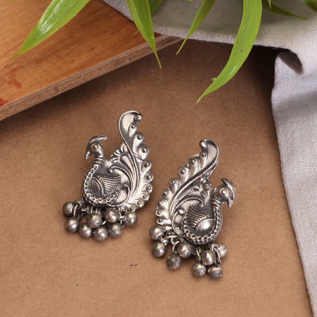 We can't get enough of earrings These earrings feature the iconic Lord Ganesha design with Trishul and tiny pearl drops that surely reflect your lively personality. A pair of earrings that will awaken the jewelry lover in you. Festive styling goes easy with this pair of earrings. Style this up with your outfit for a rich look.