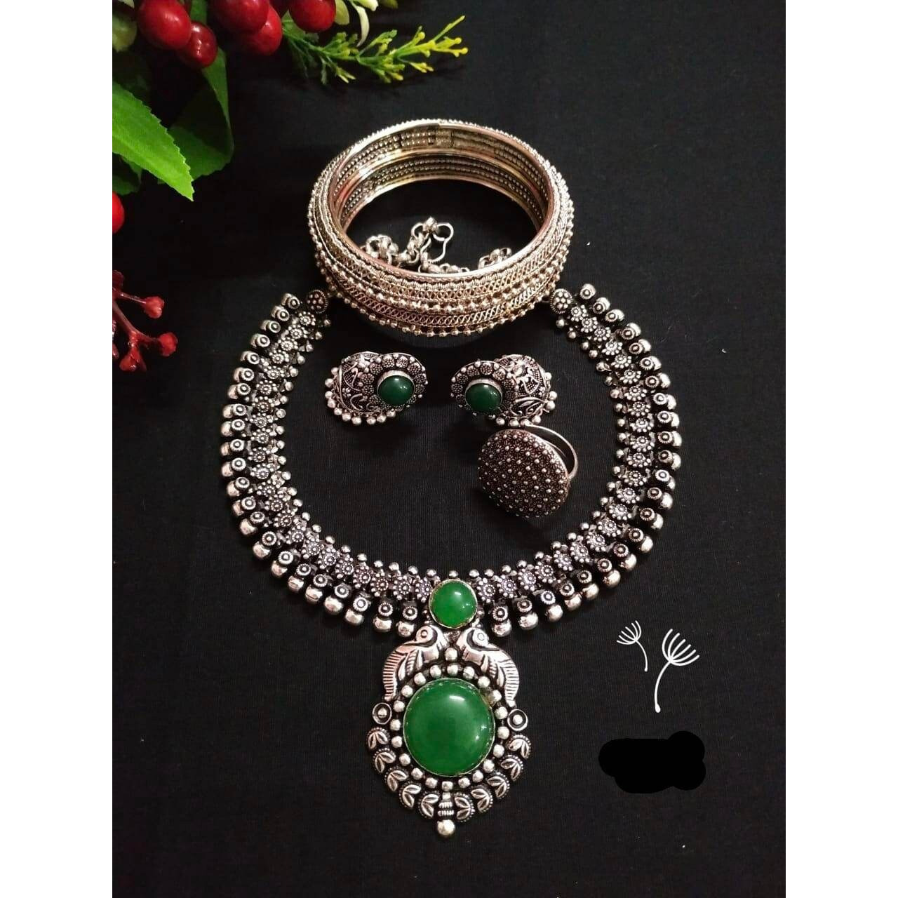 You can never go wrong with statement necklaces. Beautifully ornate with floral motifs , colourful stones & hanging pearls, this one of a kind necklace set will make you fall in love with it instantly. Handcrafted in german silver with oxidized silver plating , this glorious set has a breathtaking impact of instantly adding glam to your outfits. They look splendid with your sarees , low neck kurtas or even with your lehengas.