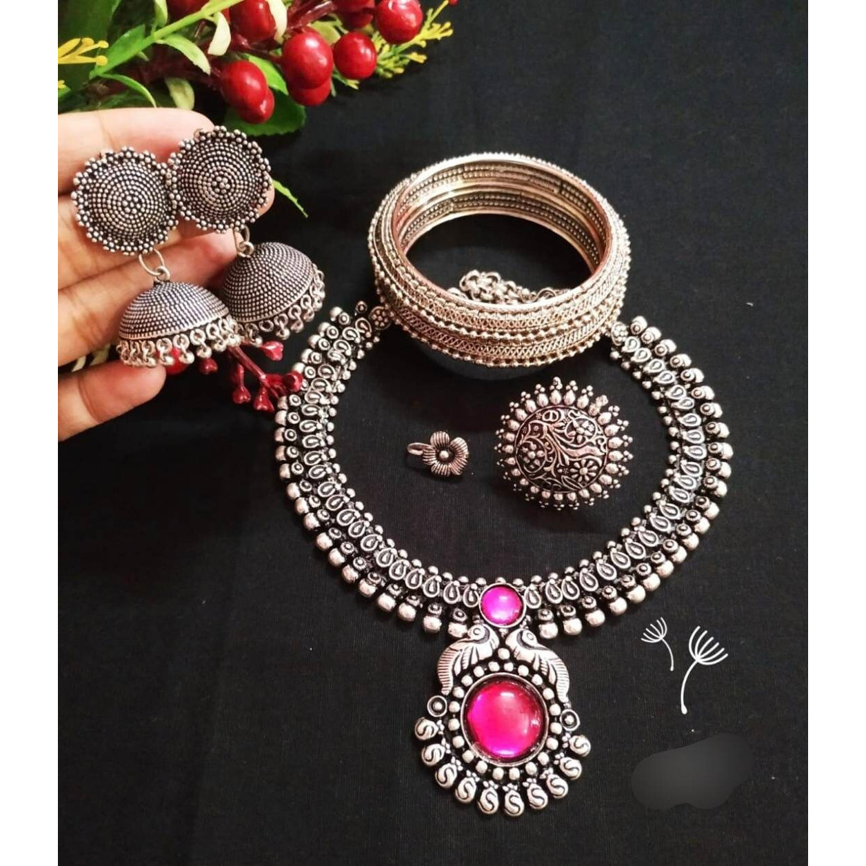 You can never go wrong with statement necklaces. Beautifully ornate with floral motifs , colourful stones & hanging pearls, this one of a kind necklace set will make you fall in love with it instantly. Handcrafted in german silver with oxidized silver plating , this glorious set has a breathtaking impact of instantly adding glam to your outfits. They look splendid with your sarees , low neck kurtas or even with your lehengas.