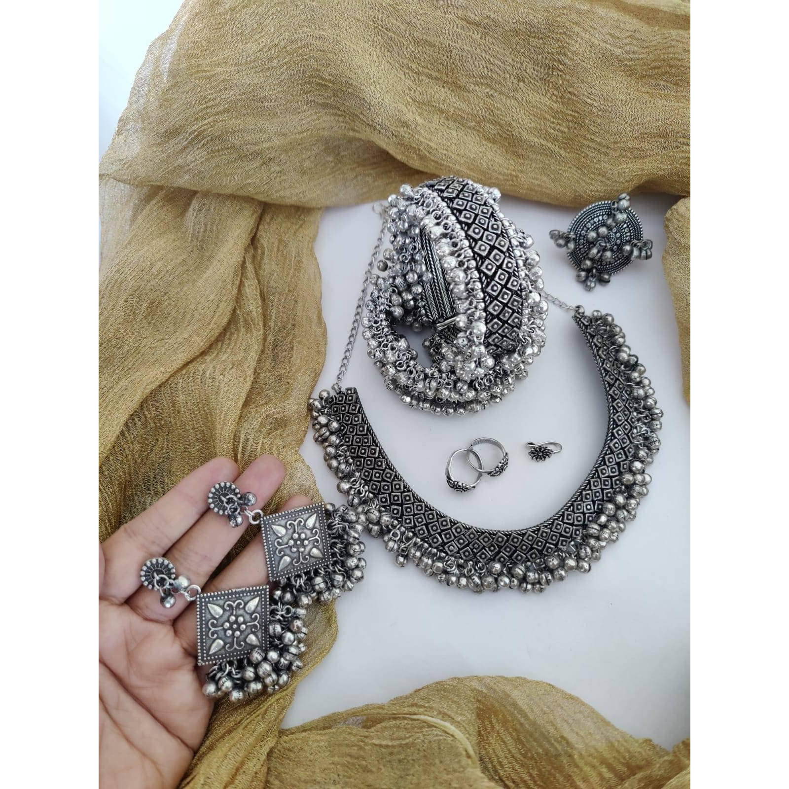 Big, bold and musical is how wed describe this statement ring that is crafted in brass and finished with the muted elegance of antique silver polish. The piece will definitely get you the attention you are looking to draw to your outfit with its sound and glamour. Easy to style, you can wear the ring as you pleaseKindly mention the style number you like in the seller message box.