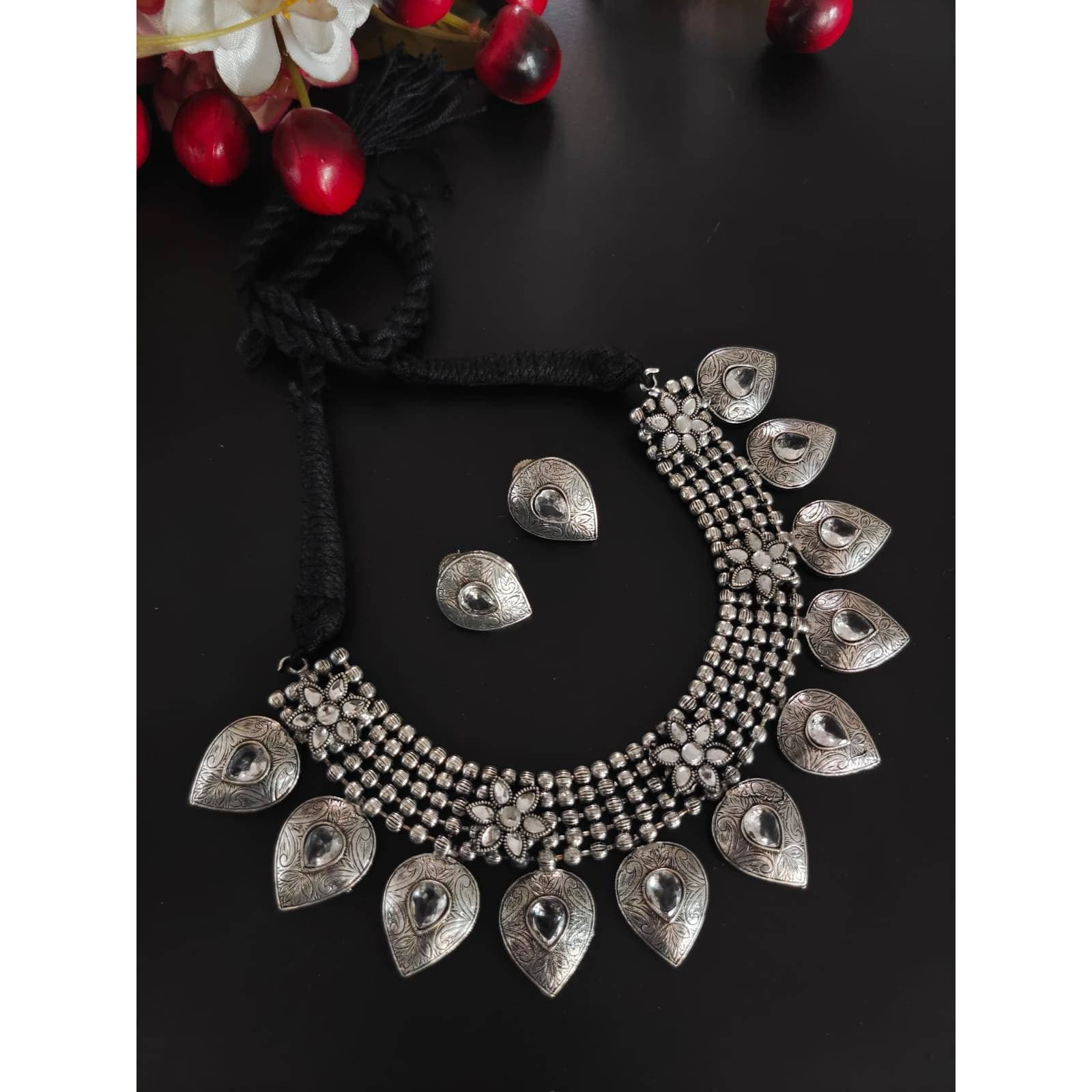 Inspired by the rich Islamic arabesque patterns and heavy ornate polki and pearl work during the mughal era , this intricately crafted stone statement earrings adds a dash of instant flair and royalty to your attires. Handcrafted in brass with pearldetails, this beautiful piece tells the story of bygone eras, heirloom jewels and sheer elegance. It adds the right finishing touch that will dress you up and leave you feeling pretty.