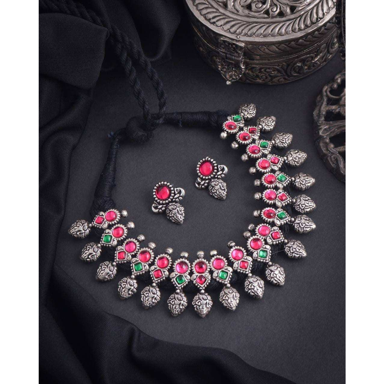 This minimalistic long oxidized necklace set is perfect for an Indian bride. Beautifullydesigned with German oxidized silver and repetitive flower patterns, this wedding set has abig intricate long Haram oxidized necklace with a choker silver necklace, a pair of studearrings, a ring, a pair of bangles, and a nose pin. This bridal oxidized set is available in three different patterns and sizes. Each of these pieces will work wonderfully on its own and even more elegant when worn together. You can
