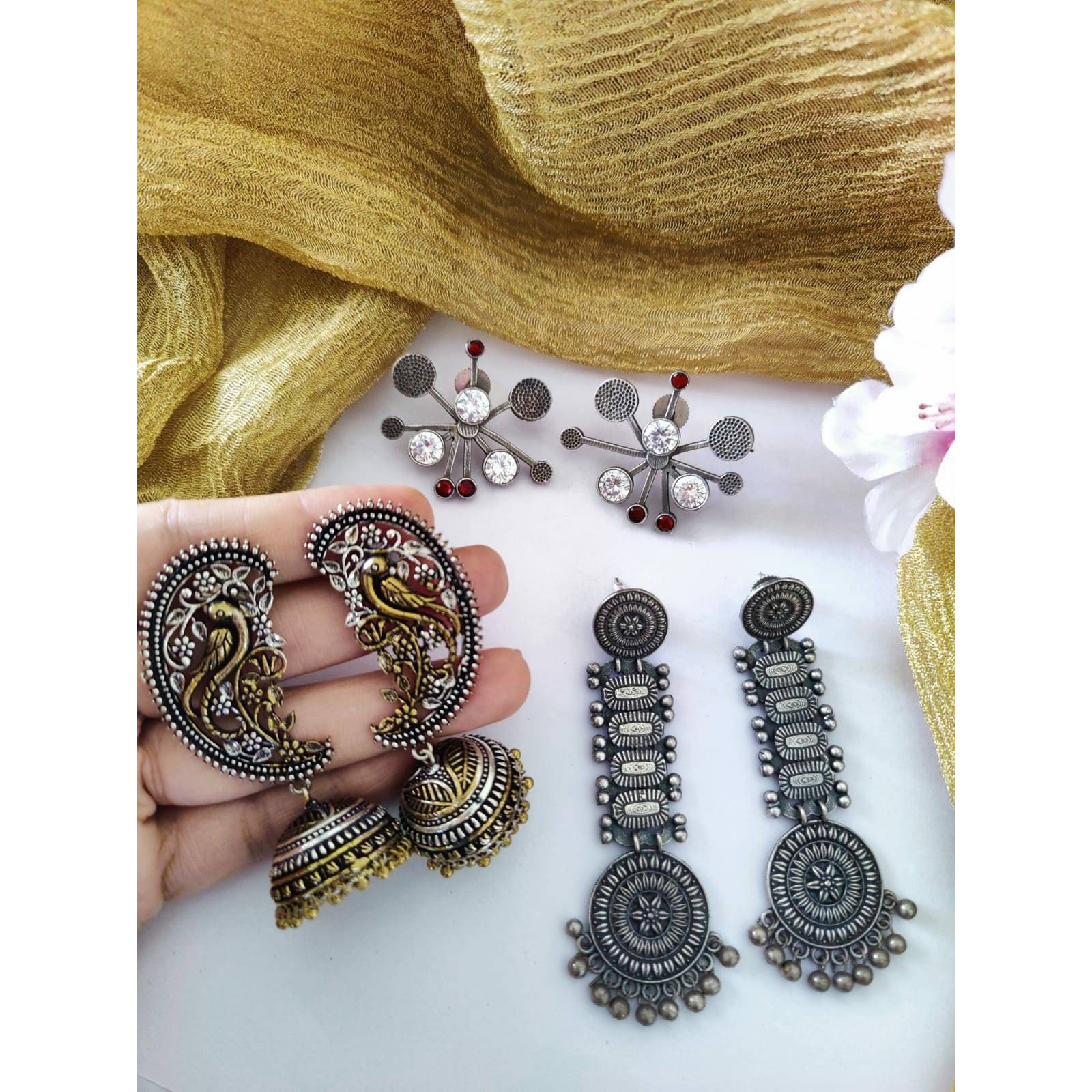 One of our favourites from our afghani collection, this gorgeous statement ring is one of a kind. Boasting of beautifully set raw cut mirror in a floral pattern, this ring is crafted in german silver and finished with oxidised silver plating. This beautiful piece is extremely versatile and can be paired with your Indian as well as well outfits.Note - The product is handmade and the mirrors are cut and pasted by hand, hence there might be certain irregularities in the finishing, which is not a de