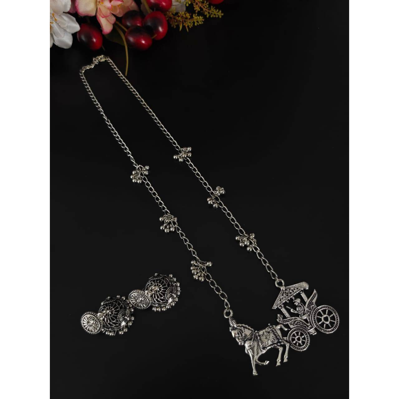 Are you ready to add collar necklaces to your wardrobe This choker set is a lightweight as well as a statement piece that you can't resist. There are beautiful enamels on the pendant along with ghungroos on the sides of the necklace which gives you a Bold and Beautiful look. These exuberant pieces create a sense of individual beauty. These pieces go well with crop tops and long skirts.