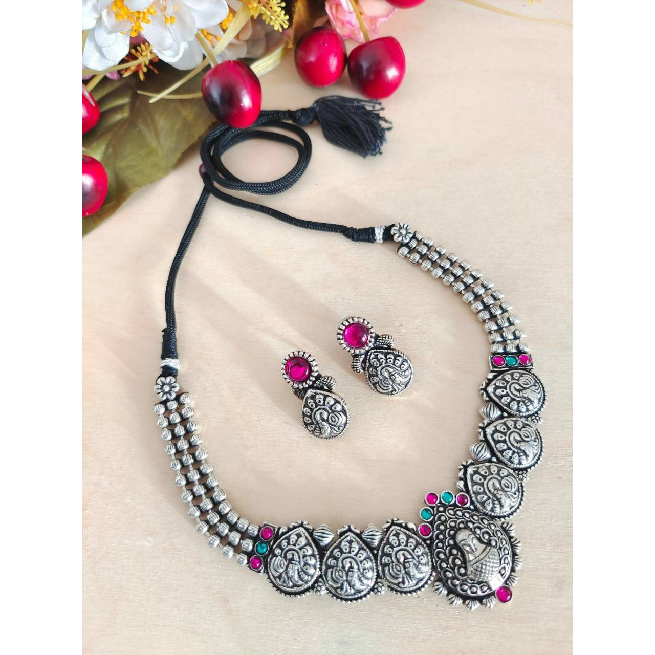 This is a beautiful Indian jewelry that is handcrafted and made in india. The jewelry comes in the pack of one silver looking necklace and a matching pair of earrings. The oxidized necklace is embedded with green stones and so is the earrings. This piece will prove to be a treasure in your cupboard. On buying this jewelry set get a free and assured gift on every purchase.Care Instruction To maintain the shine of the jewelry make sure to clean with a clean white tissue or cloth. Do not use any h