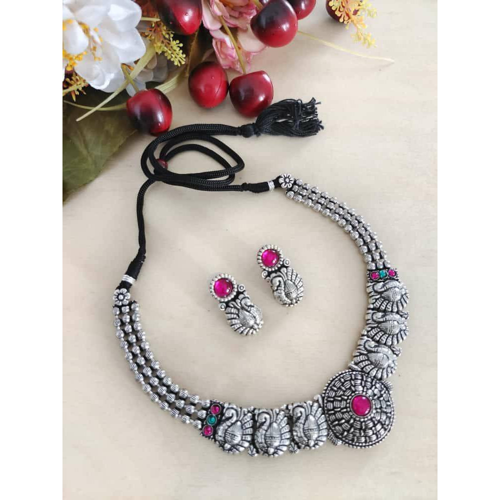 This is a beautiful Indian jewelry that is handcrafted and made in india. The jewelry comes in the pack of one silver looking necklace and a matching pair of earrings. The oxidized necklace is embedded with green stones and so is the earrings. This piece will prove to be a treasure in your cupboard. On buying this jewelry set get a free and assured gift on every purchase.Care Instruction To maintain the shine of the jewelry make sure to clean with a clean white tissue or cloth. Do not use any h