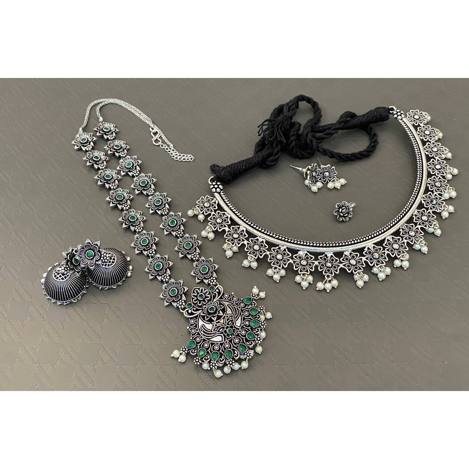 Are you a big fan of boho and tribal-inspired oxidized jewelry Then this set can be your match made in heaven. Studded with beautiful little tribal-themed mirrors and adorned with cute little ghungroos, this set of Indian oxidized jewelry comprises an elegant necklace, a pair of matching earrings, and beautiful oxidized bracelets. The jewelry comes with an extra plating of silver for longer sustainability. It can be a great gift for your loved ones. You need to ensure that you store it in an ai