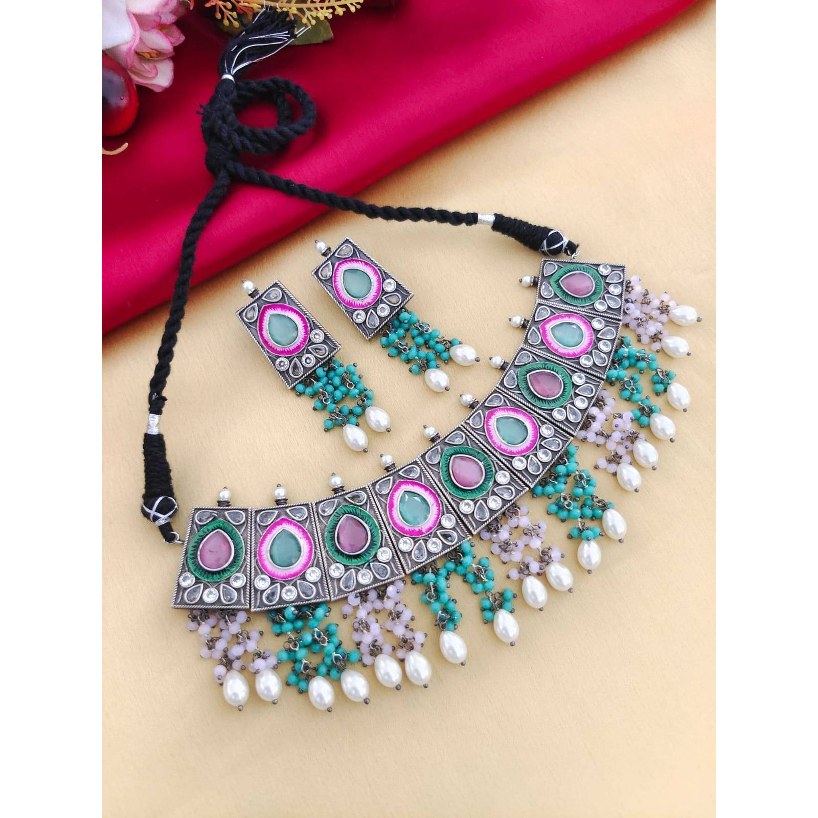 Hand crafted to perfection this dual tone bead necklace is the resplendent image of our design. The three beaded layer of this necklace exquisitely holds the silver and gold colored beads stacked in strings and adds richness and sophistication to the ensemble