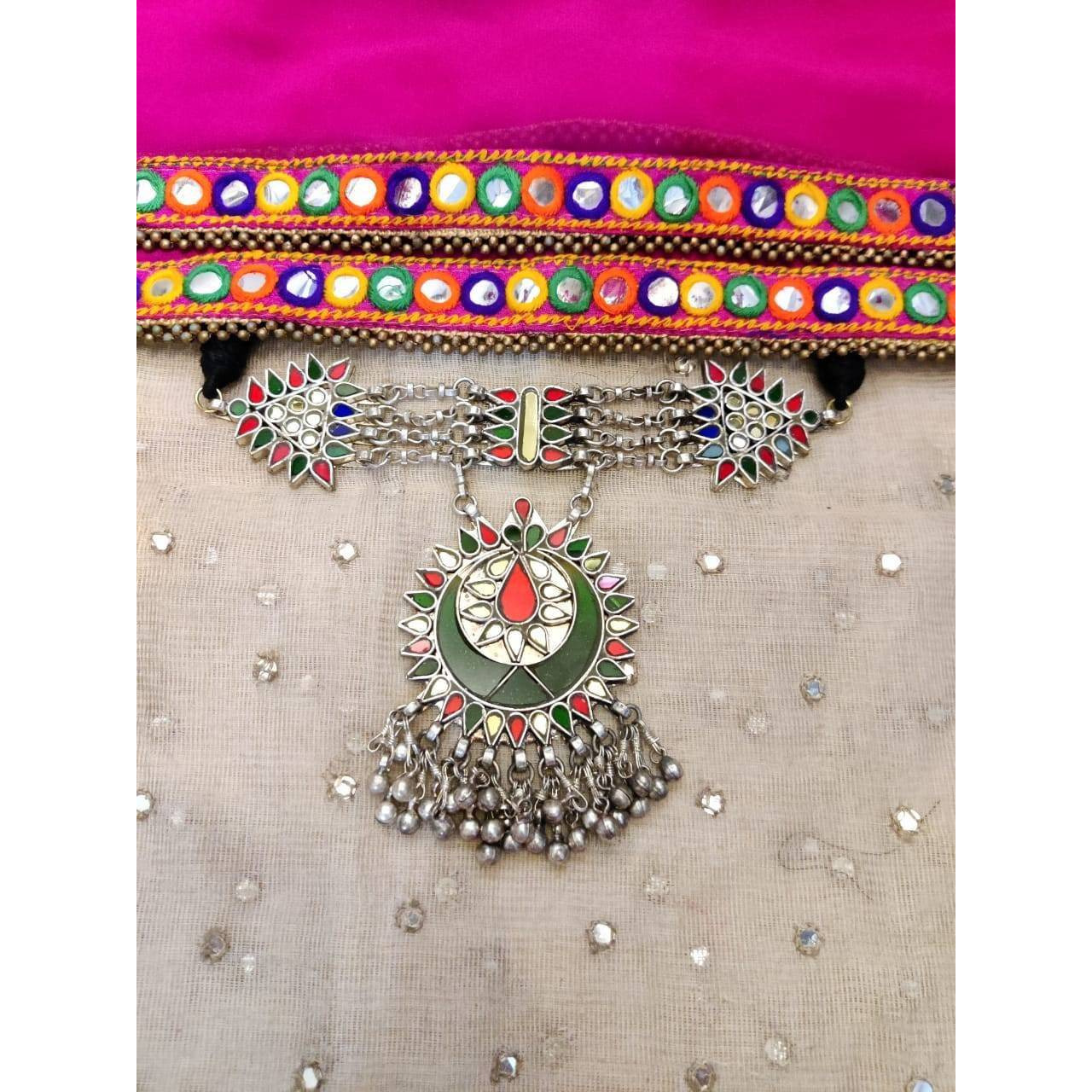 This Afghani Choker Necklace is crafted in oxidized silver that is a perfect amalgamation of beautiful multi-color enamel work and perky ghungroos that will lace your collar to give you a rich and vibrant look. Style this up for a high-statement boho look.