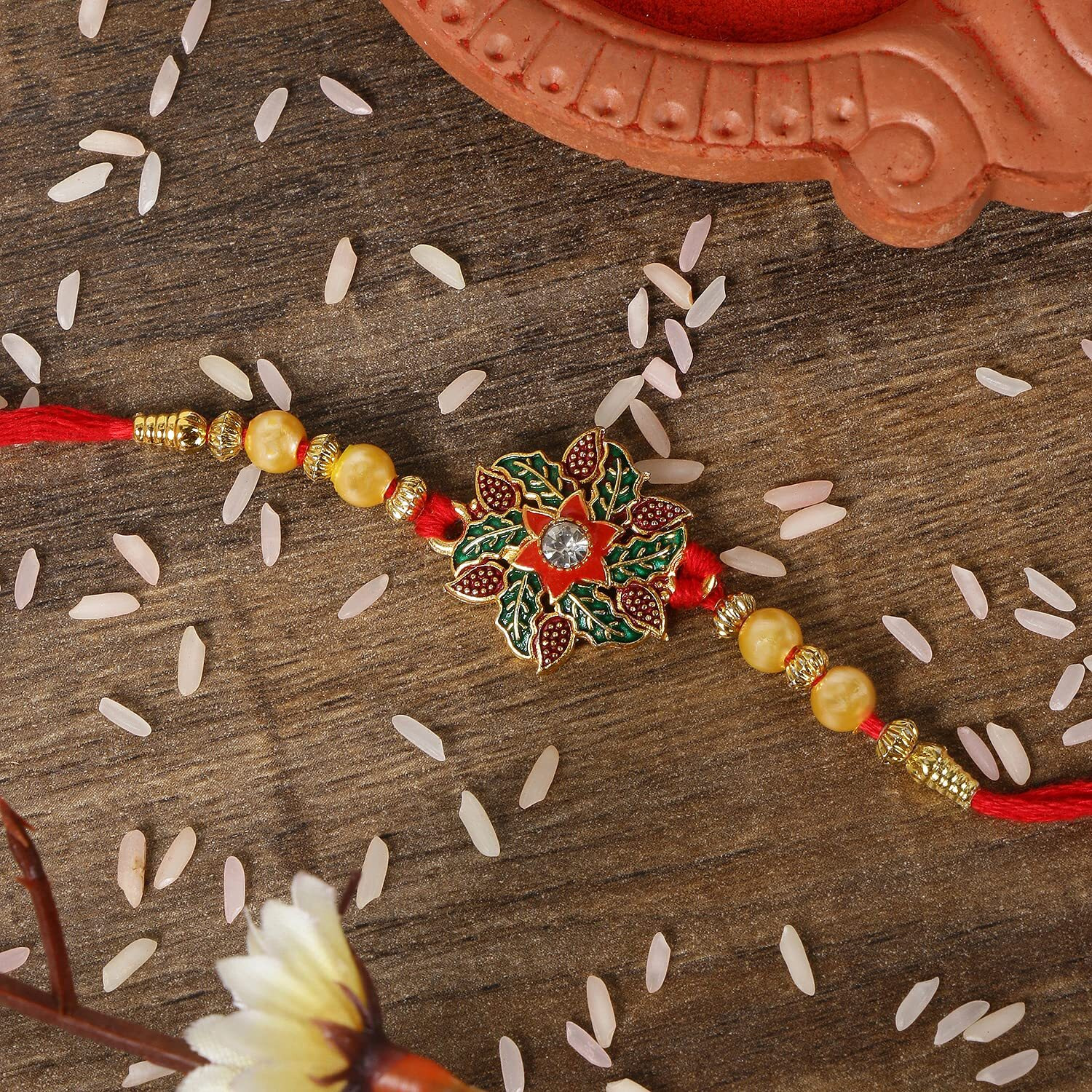 Riddhika Ventures Fabulous Gold Plated Flower and Meenakari Ganesh Rakhi (Set of 2) with Roli Chawal and Greeting Card (E1G1)
