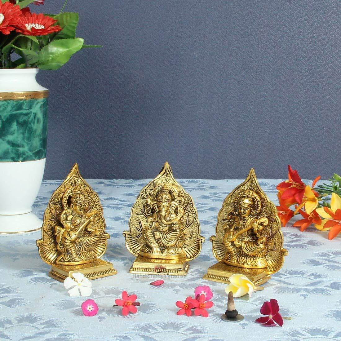 Handicrafts Paradise Metal Antique Golden Finish Lakshmi Ganesh and Saraswati Ji with Leaf Backdrop, 4 x 2 x 5 inch, 3 Piece