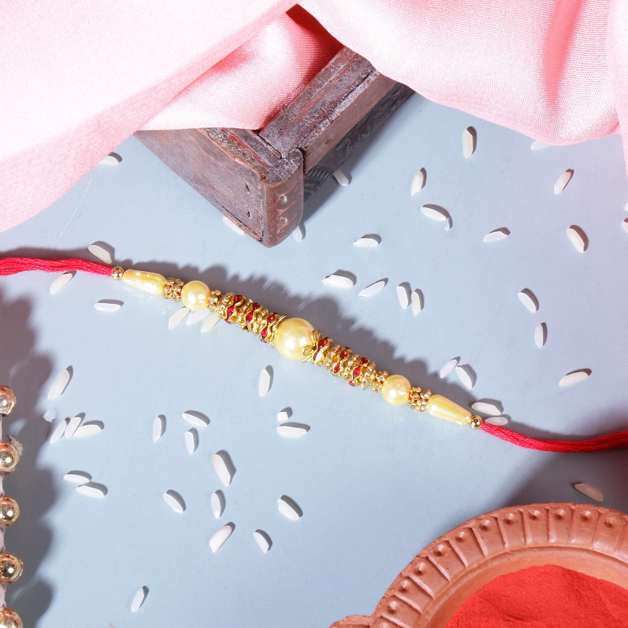 Riddhika Ventures Base Metal With Pearl Festival Rakhi Bracelet With Roli Chawal And Greeting Card For Men (multicolour)