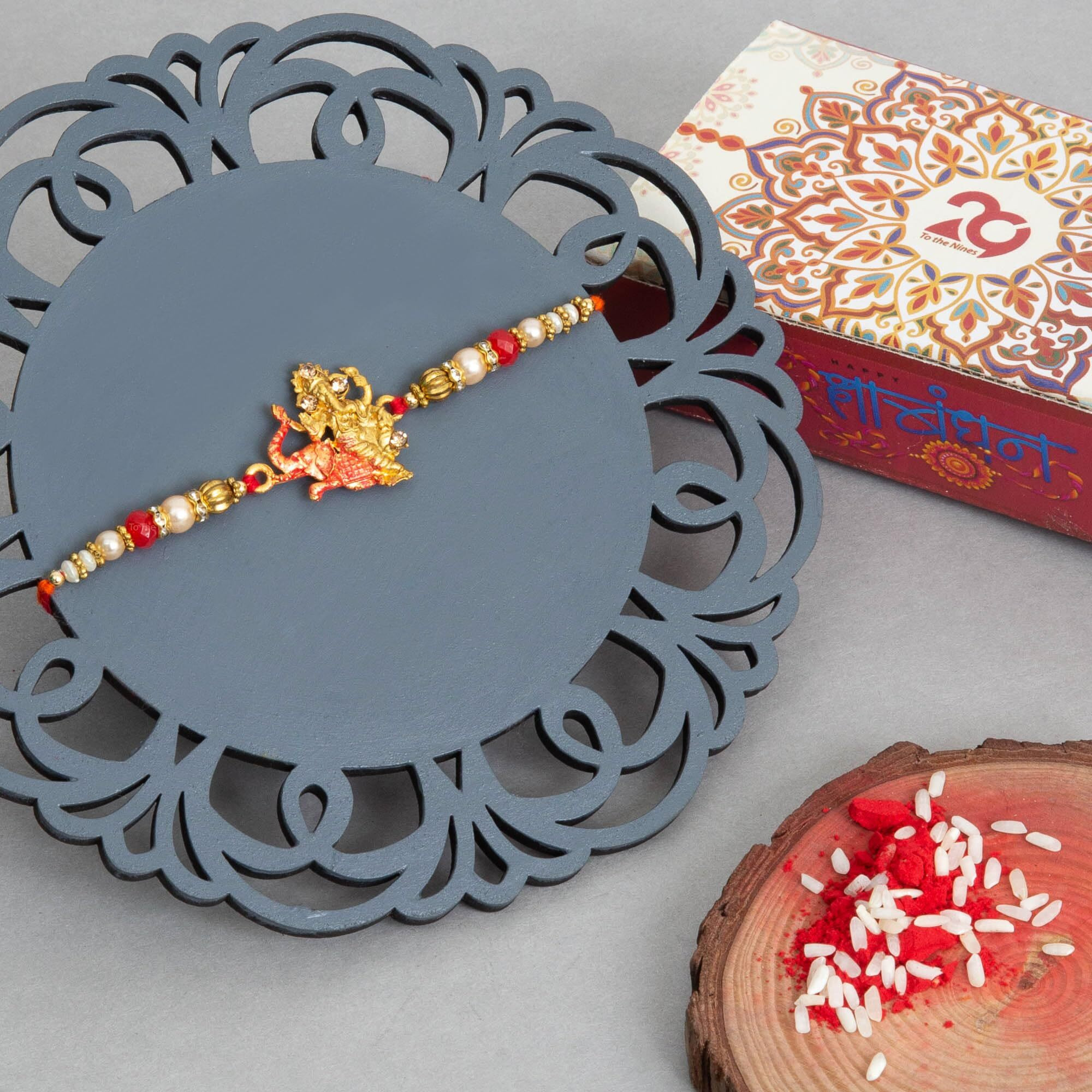 To The Nines Elegant Ganesha Red Rakhi for Beloved Brother with Tilak Material