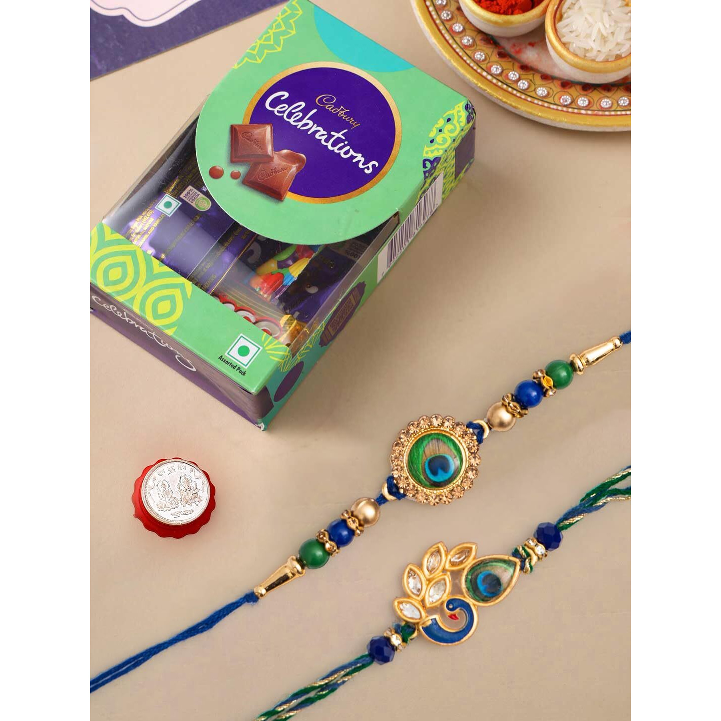 CraftVatika Rakhi Gift for Brother and Bhabhi With Chocolate Pooja Coin Combo| Mor Pankh Rakhi for Men Boy Bhaiya Girls |Cadbury Celebrations with Rakhi with Chocolate Gift Pack Rakhi Set of 2