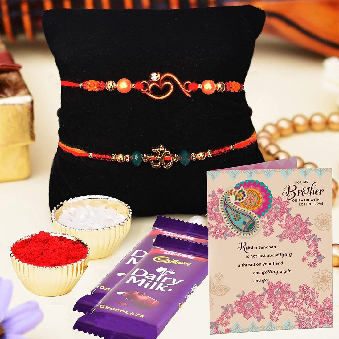 ARCHIES Rakhi for Brother Rakshabandhan Combo of 1 Majestic Ganesha Idol, 2 Auspicious Om Rakhis and 2 Dairy Milk Chocolates 13.2gm With 1 Roli & Chawal Set-10gm & Greeting Card (Pack of 7)