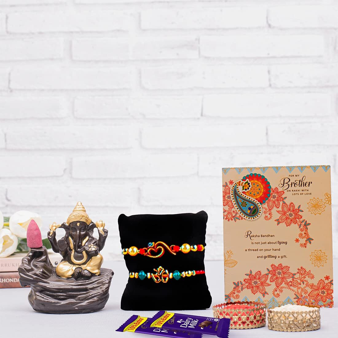 ARCHIES Great Rudraksh Rakhi for Brother Rakshabandhan Combo of 1 Rakhi, 1 Ganesh Laxmi Coin With 1 Roli&Chawal-10gm, 1 Exotic Assorted Chocolates-30 gms(Dates and Almonds) & Greeting Card (Pack of 5)