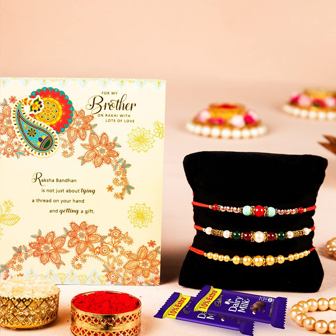 ARCHIES Rakhi For Brother Rakshabandhan Combo Set of 3 Crystal Stone Bhaiya/Bro/Bhai Rakhis with Greeting Card, 2 Dairy Milk Chocolates 24 gms, Roli Chawal 10 gms Pack (Gift pack of 7)
