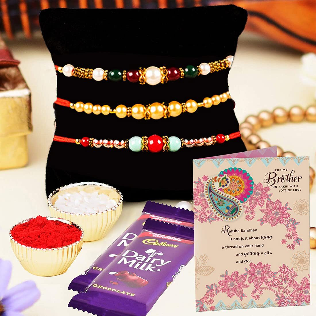 ARCHIES Rakhi For Brother Rakshabandhan Combo Set of 3 Crystal Stone Bhaiya/Bro/Bhai Rakhis with Greeting Card, 2 Dairy Milk Chocolates 24 gms, Roli Chawal 10 gms Pack (Gift pack of 7)