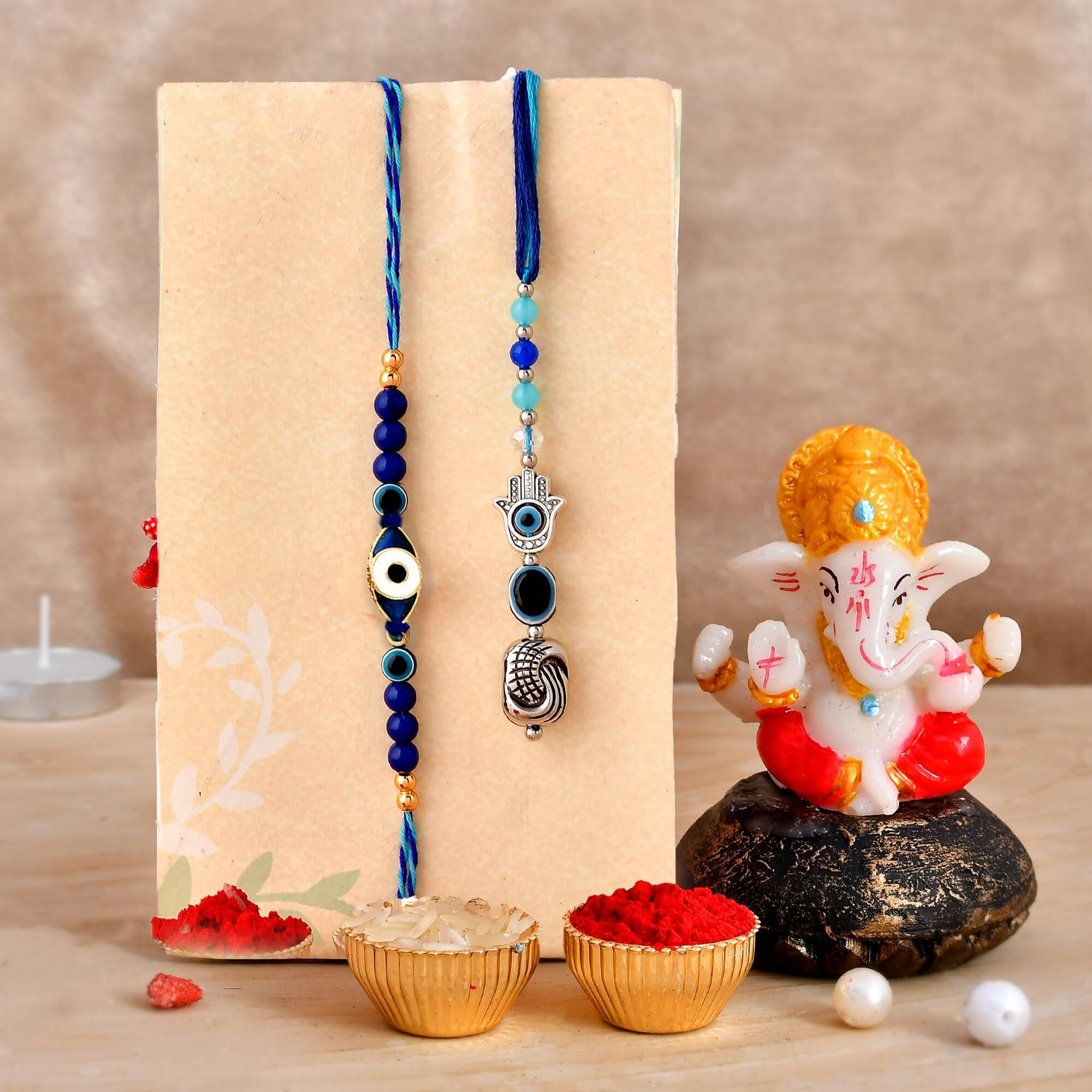 CraftVatika Rakhi Gift for Brother Bhabhi with Ganesha Showpiece Combo Gift- Evil Eye Rakhi, Designer Rakhi for Brother Bhabhi with Figurine