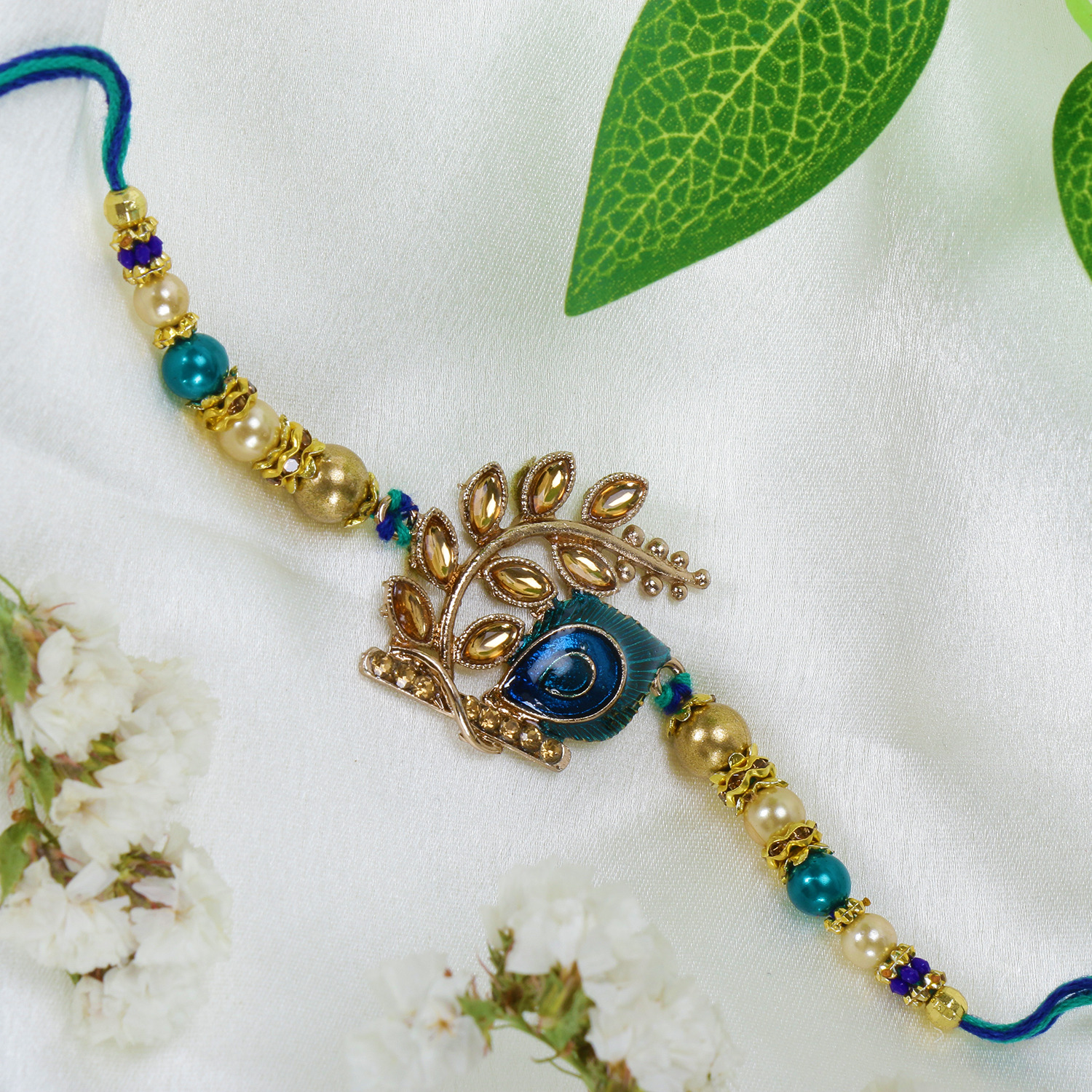 Riddhika Ventures Stylish Peacock Feather and Kundan Rakhi with Roli Chawal and Greeting Card (K3)