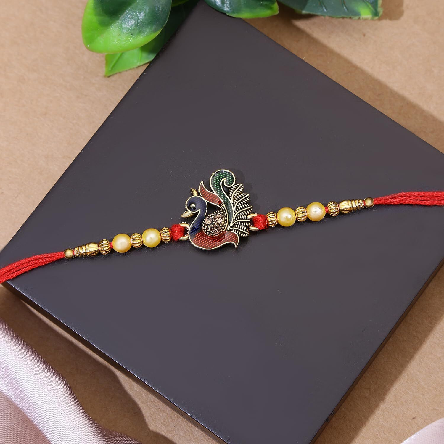 Riddhika Ventures Fabulous Gold Plated Flower and Meenakari Ganesh Rakhi (Set of 2) with Roli Chawal and Greeting Card (M1P7)