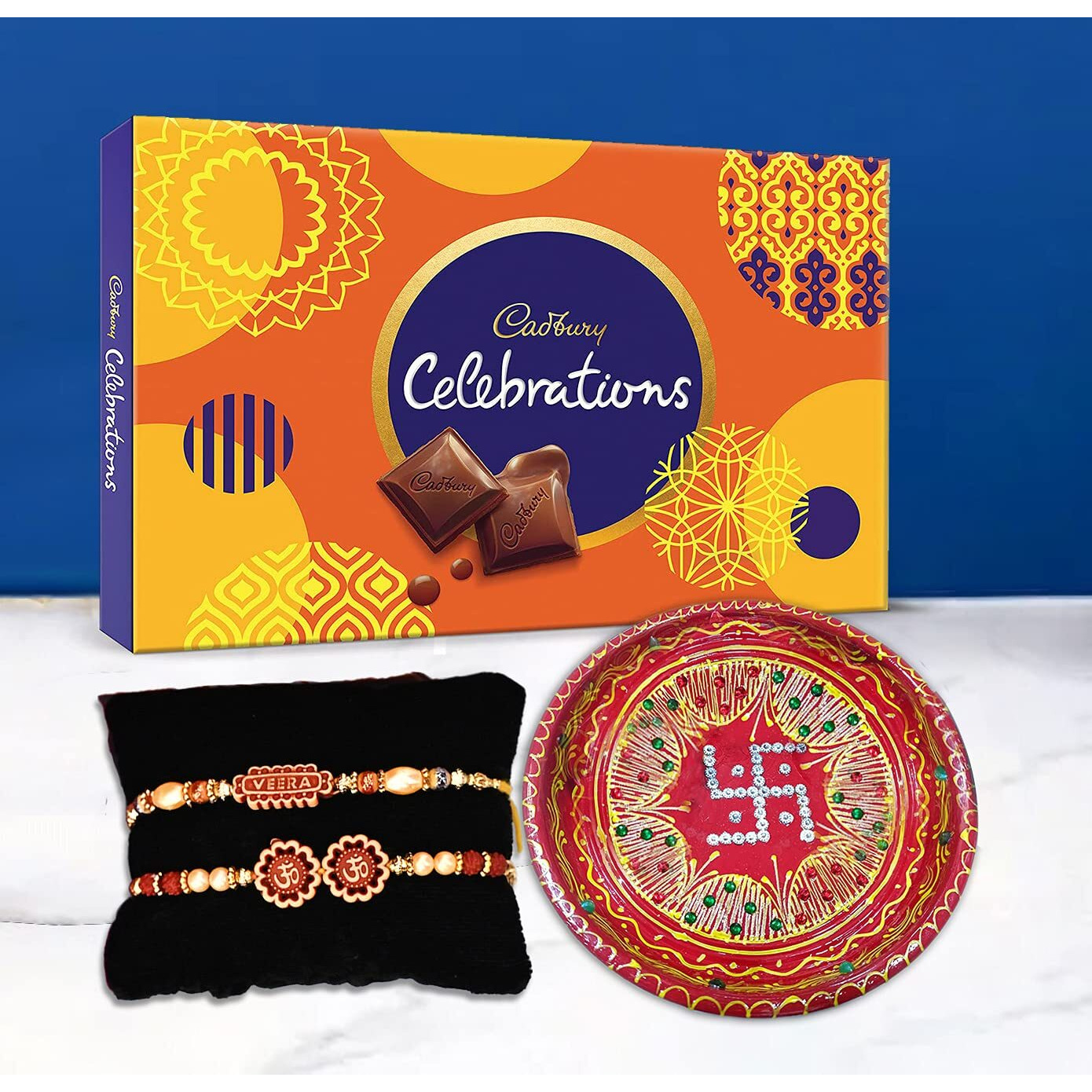 Collectible India Rakhi Thali Set With Diya For Brother Bhabhi , Rakhi Set of 2 Veera Om Rakhi & Cadbury Celebration Chocolate Gift Set for Brother [Gift Combo - Rakhi with Cadbury Chocolate and Decorative Thali Set Gift Tilakk Material & Greeting Card
