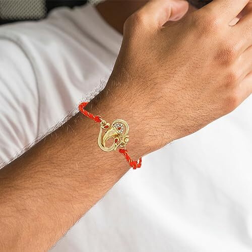 Estele Gold Plated Om Ganesh Bracelet With Austrian Crystals, Enamel And Divine Red Silk Thread For Men