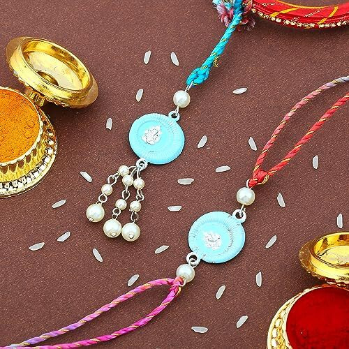 Estele Rhodium Plated Divine Ganesh Adjustable Rakhi Set For Bhaiya & Bhabhi With Blue Enamel And White Pearls With Multi-Colored Silk Thread