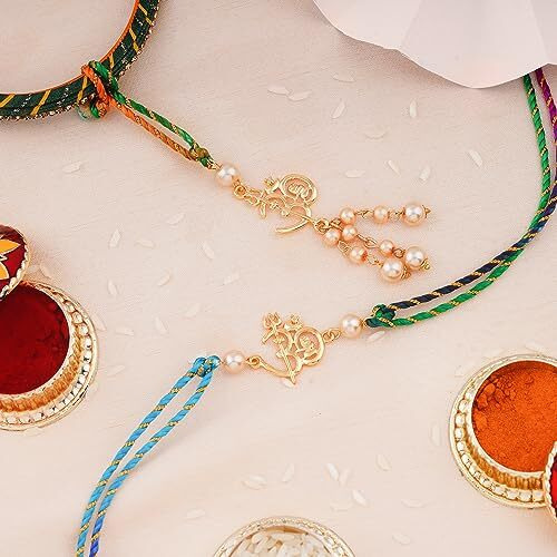 Estele Gold Plated Shivay Om Rakhi Set For Bhaiya Bhabhi With Creamy Pearls And Multi-Colored Silk Thread