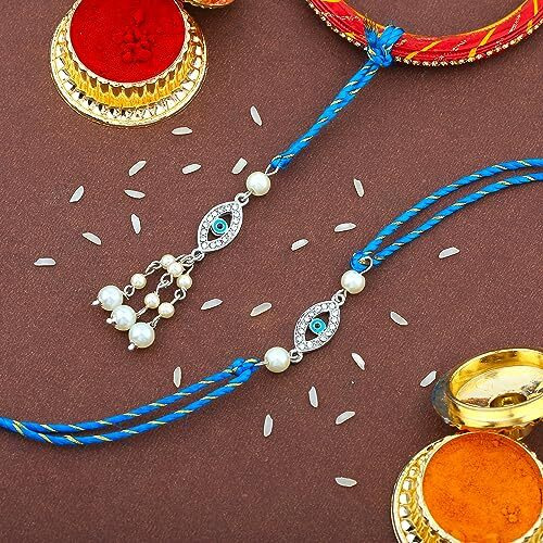 Estele Rhodium Plated Auspicious Evil Eye Rakhi Set For Bhaiya Bhabhi With Blue Enamel And White Austrian Crystals With Fancy Silk Thread