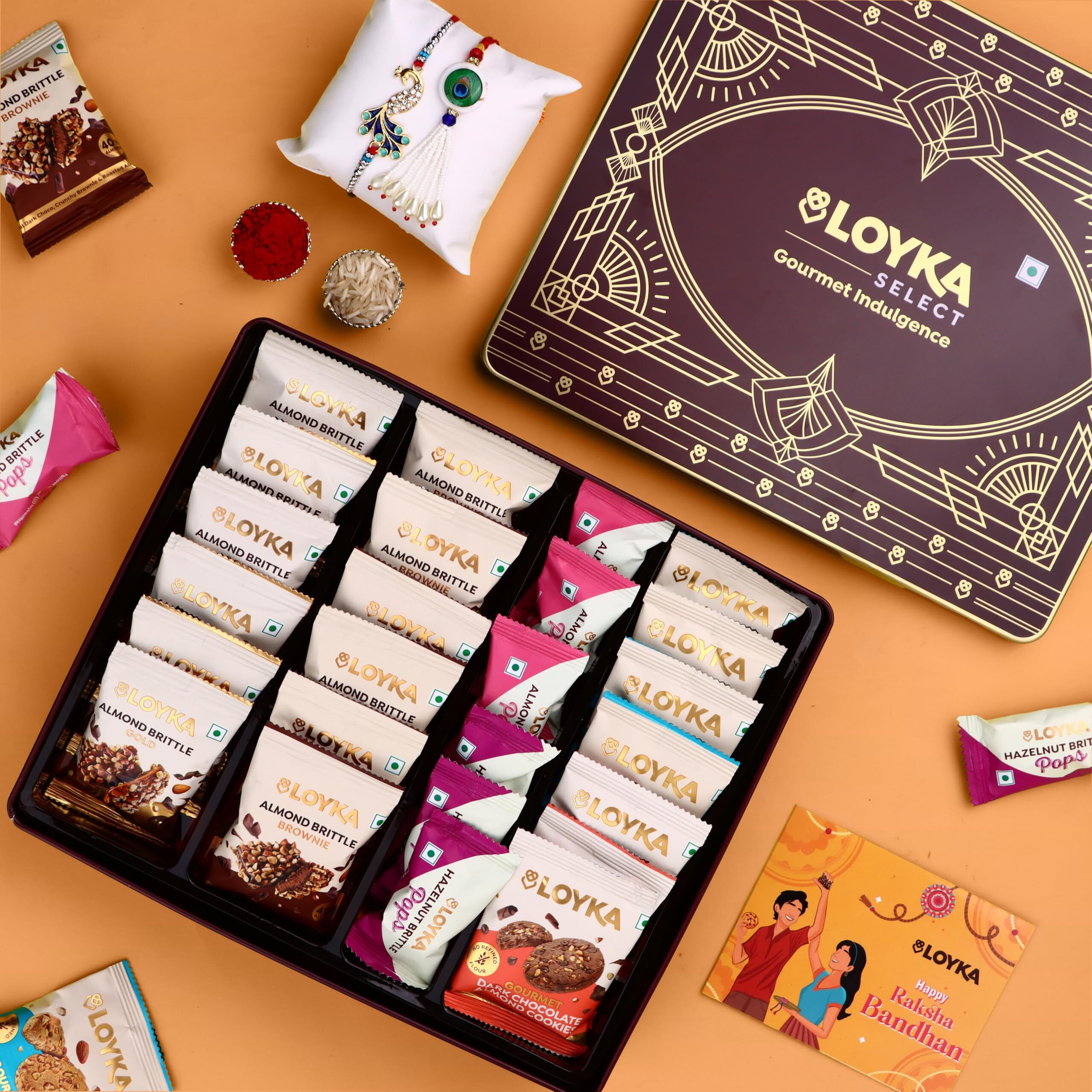 Loyka Select Regal Tin (Reusable) With Bhaiya Bhabhi Rakhi, Roli, Chawal & Card  A Luxurious Gifting Delight With 5 Almond Brittle Gold, 5 Brownie, 8 Pops, 6 Cookies & Rich Dark Chocolate Almond Treats  Perfect For Celebrations & Special Moments
