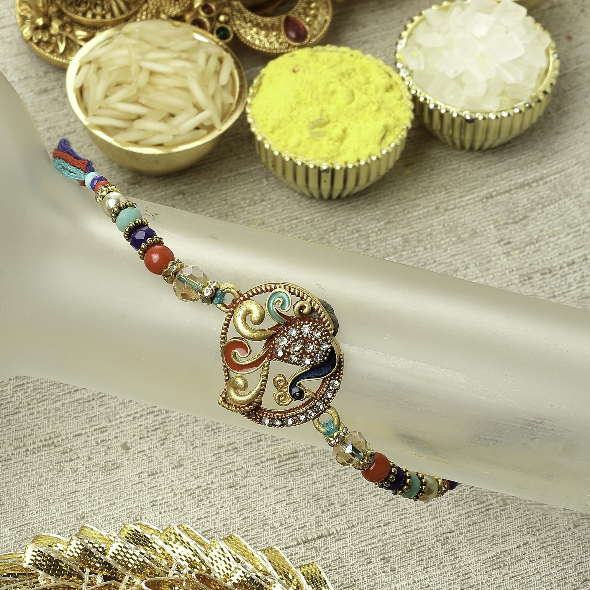 Zeneme Rakhi For Bhai Gold-Plated Craved & Enamelled Mor Rakhi With Roli Chawal And Raksha Bandhan Greeting Card For Bhaiya