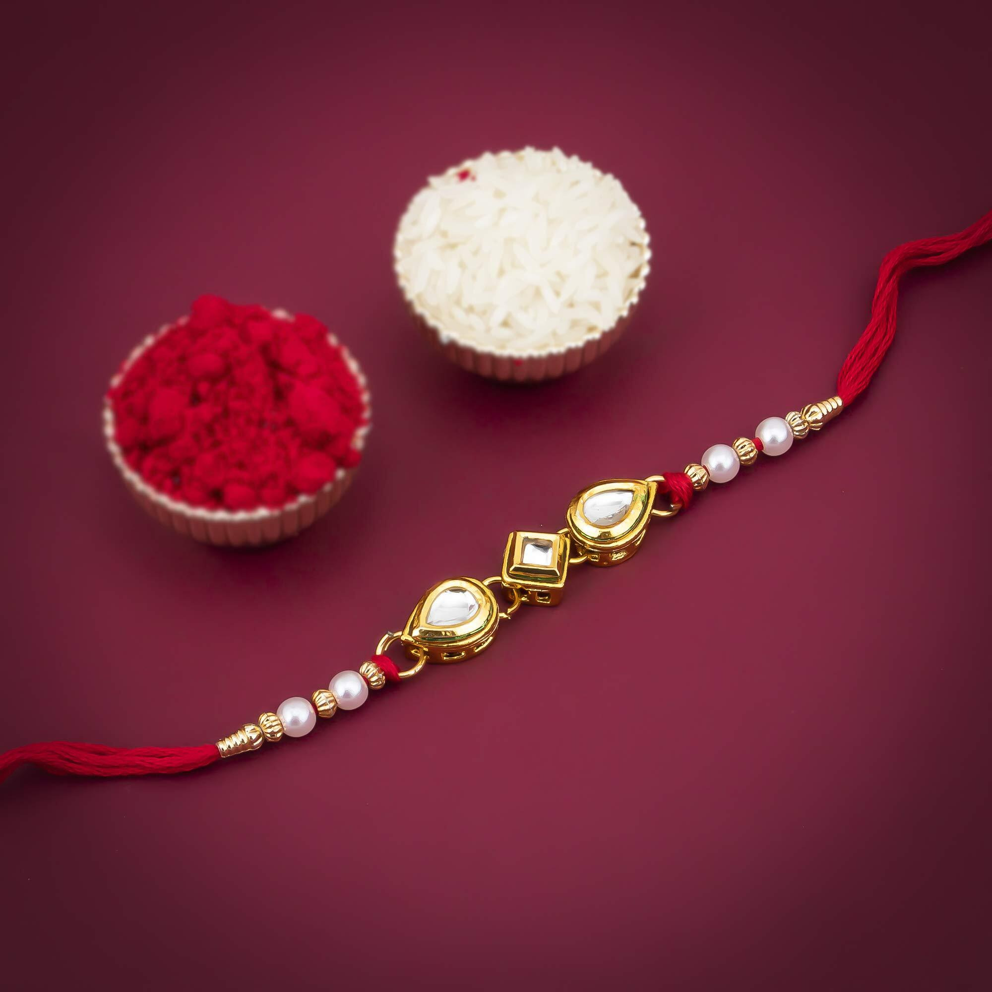 Sukkhi Rakhi Cultivated Kundan Designer Gold Plated Premium Rakhi For Brother With Roli Chawal & Greeting Card | Rakhi For Bhaiya | Rakhi For Men | Kundan Rakhi | (Rak73414)
